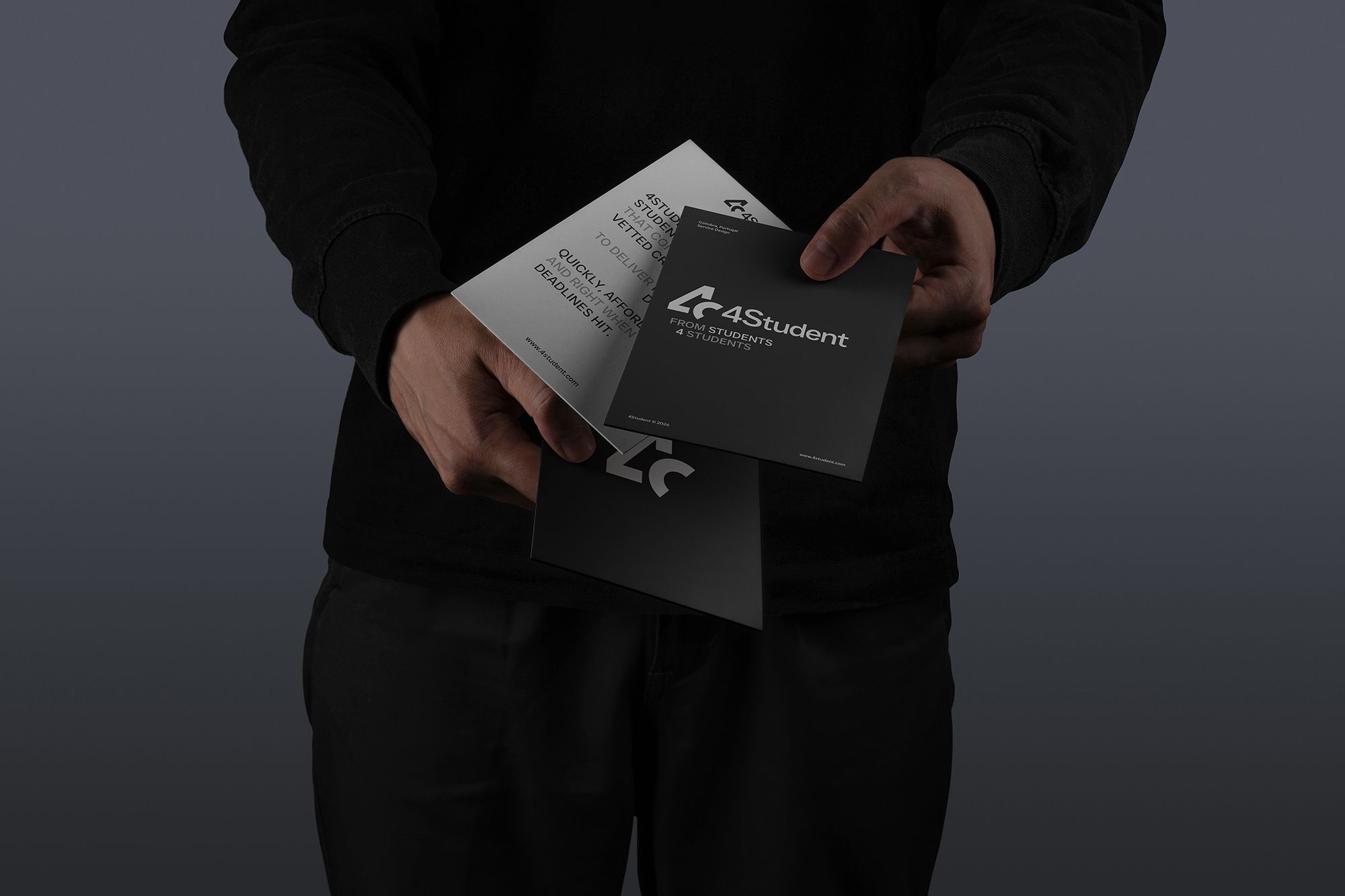 Hands holding 4Student printed material